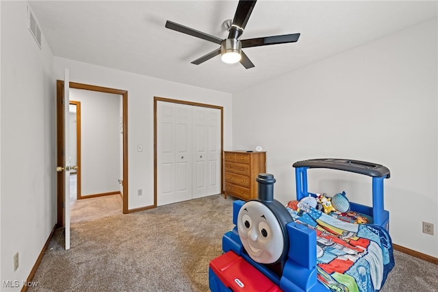 carpeted bedroom featuring baseboards, ceiling fan, a closet, and visible vents
