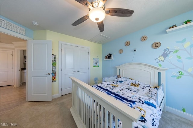 bedroom featuring baseboards, light carpet, ceiling fan, and a closet