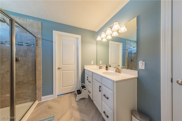 full bathroom with a sink, a stall shower, and double vanity