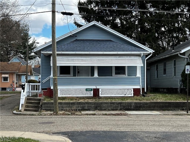 view of front facade with a porch and a shingled roof