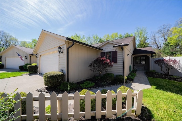 single story home with fence private yard, a garage, driveway, and a front yard
