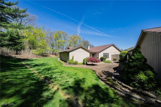 back of property with a lawn