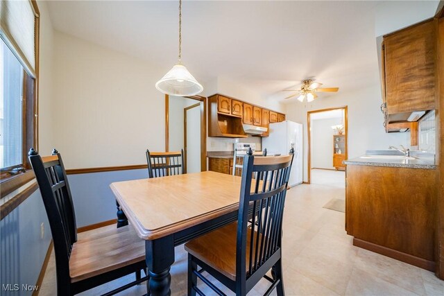 dining room with baseboards and a ceiling fan