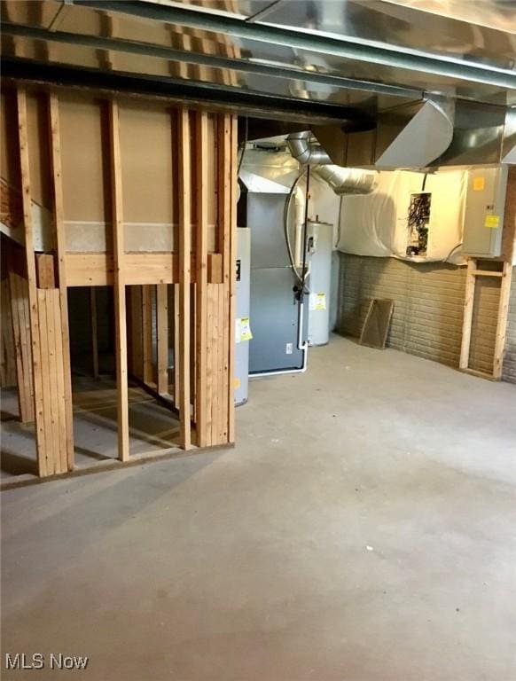 unfinished below grade area featuring water heater and electric panel