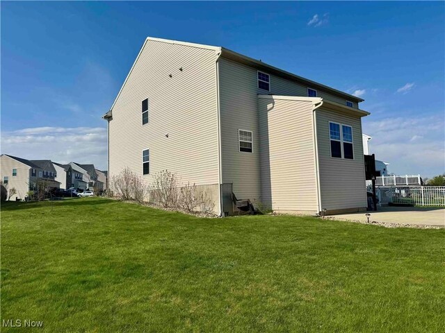 view of side of property with a lawn