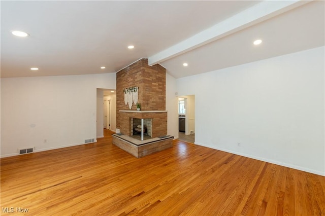 unfurnished living room featuring baseboards, visible vents, lofted ceiling with beams, and light wood-type flooring