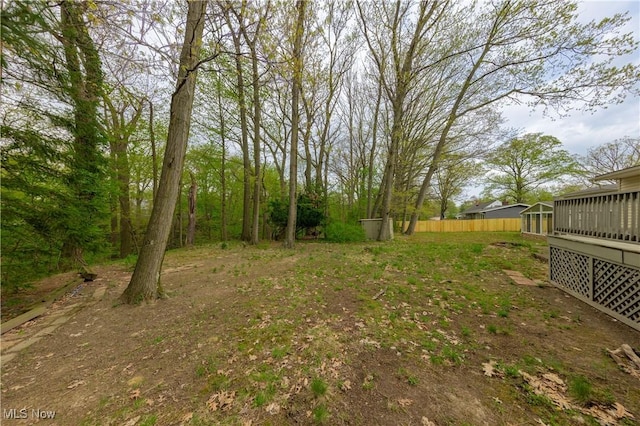 view of yard featuring fence and a sunroom