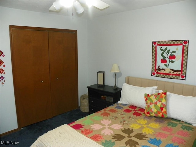 carpeted bedroom with ceiling fan and a closet