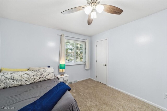 bedroom featuring carpet floors, a ceiling fan, baseboards, and visible vents