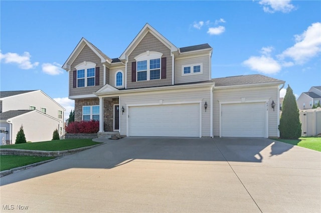 view of front of home featuring an attached garage, driveway, and stone siding