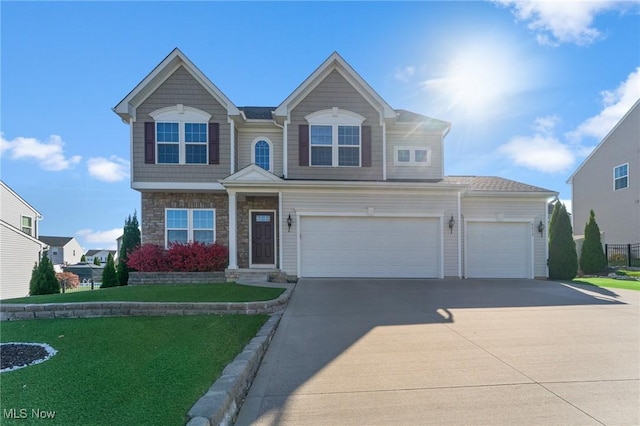 view of front facade featuring an attached garage, a front yard, driveway, and stone siding