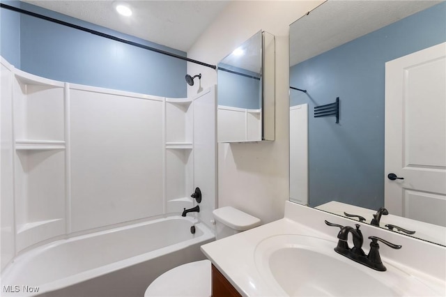 bathroom with vanity, toilet, and  shower combination