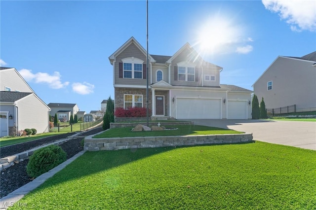 view of front of home featuring a garage, fence, stone siding, a front yard, and concrete driveway