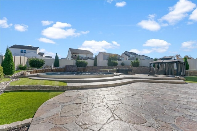 view of community featuring a residential view, a gazebo, a fenced backyard, a patio area, and a swimming pool