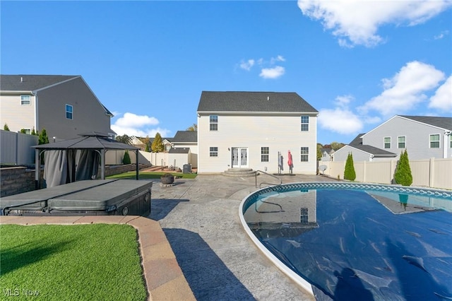 view of swimming pool with a gazebo, a fenced backyard, a patio area, and a residential view