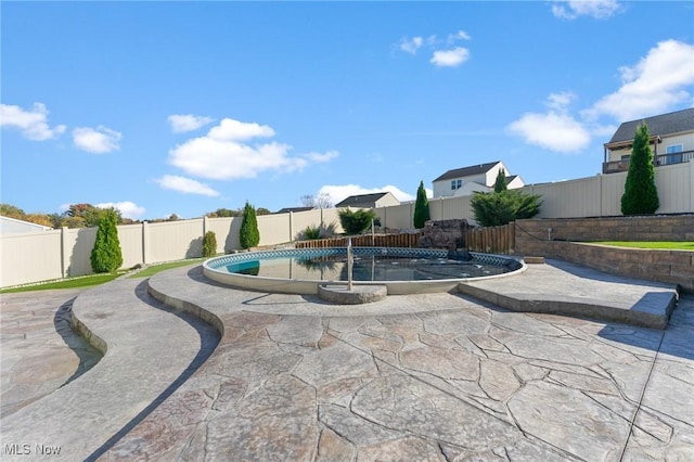 view of swimming pool with a fenced in pool, a fenced backyard, and a patio area