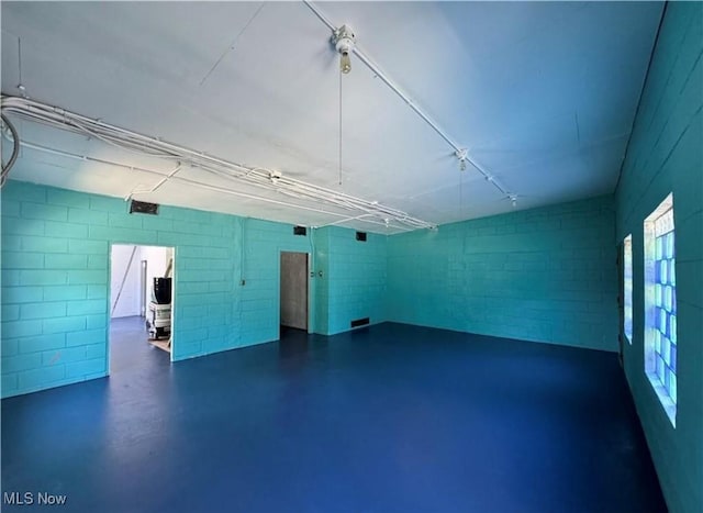 interior space with concrete block wall
