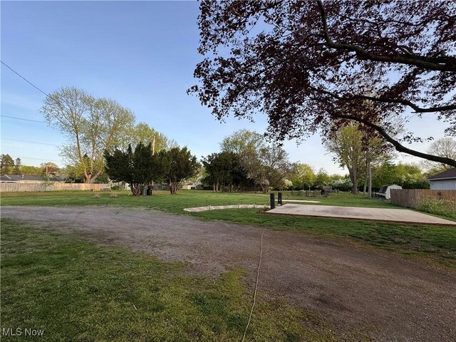surrounding community featuring fence and a yard