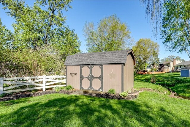 view of shed featuring fence
