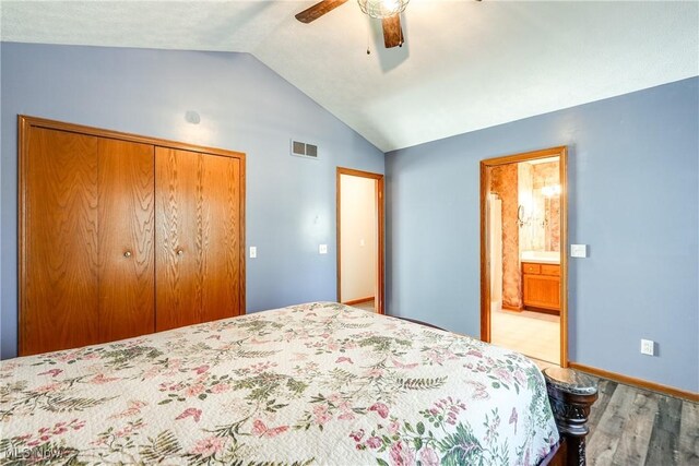 bedroom with ceiling fan, visible vents, vaulted ceiling, wood finished floors, and a closet