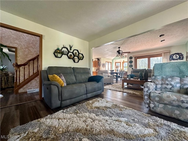 1218 Ohltown Mcdonald Rd, Mineral Ridge, OH 44440 - living area featuring wood finished floors, a textured ceiling, a ceiling fan, and stairs