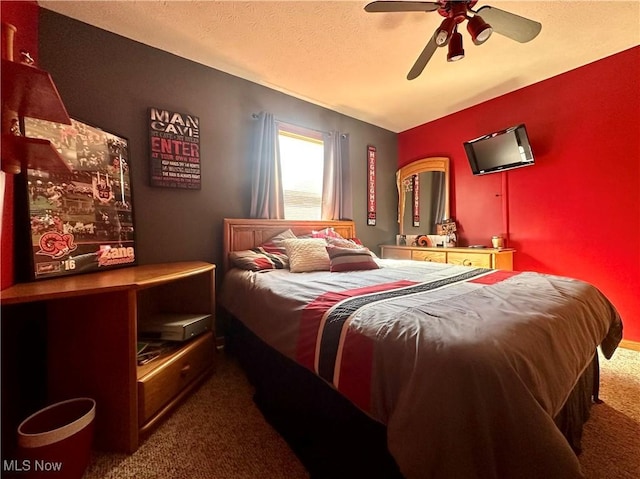 carpeted bedroom with a ceiling fan and a textured ceiling
