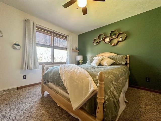 carpeted bedroom featuring visible vents, a ceiling fan, and baseboards