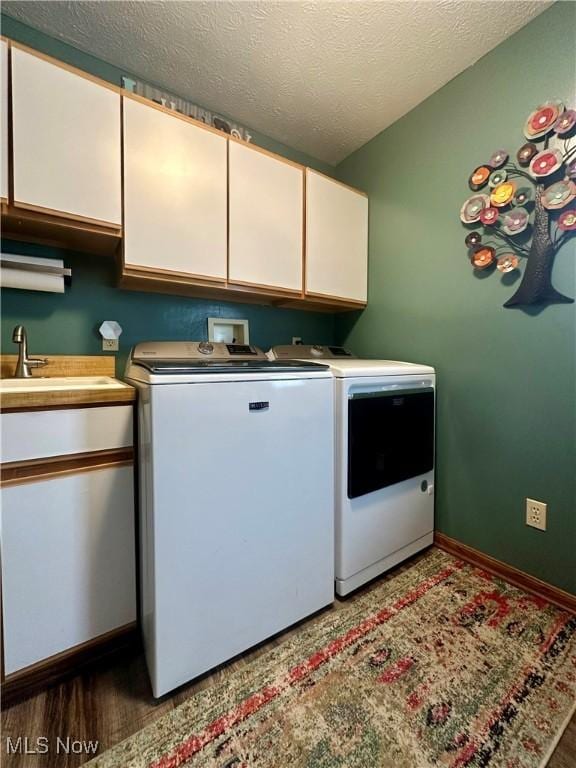 1218 Ohltown Mcdonald Rd, Mineral Ridge, OH 44440 - laundry room featuring cabinet space, washer and dryer, and a textured ceiling