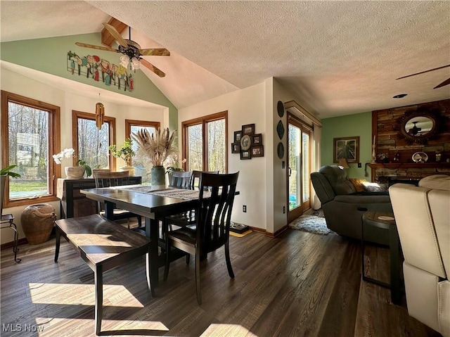 dining room with a ceiling fan, baseboards, lofted ceiling with beams, and dark wood-type flooring
