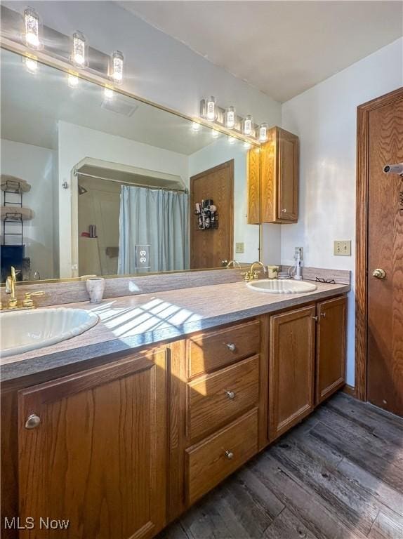 1218 Ohltown Mcdonald Rd, Mineral Ridge, OH 44440 - full bathroom with wood finished floors, double vanity, and curtained shower