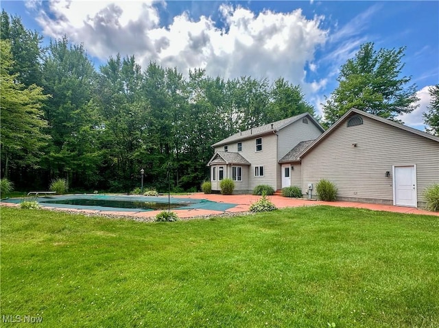 1218 Ohltown Mcdonald Rd, Mineral Ridge, OH 44440 - rear view of house featuring a patio area, a lawn, and a covered pool