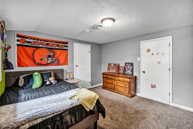 carpeted bedroom featuring a textured ceiling, baseboards, and lofted ceiling
