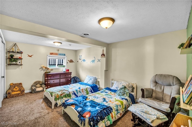 bedroom with visible vents, a textured ceiling, carpet, and baseboards