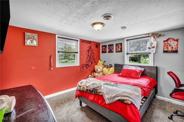 carpeted bedroom featuring a textured ceiling, baseboards, and visible vents
