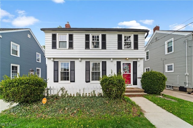 colonial home featuring a chimney