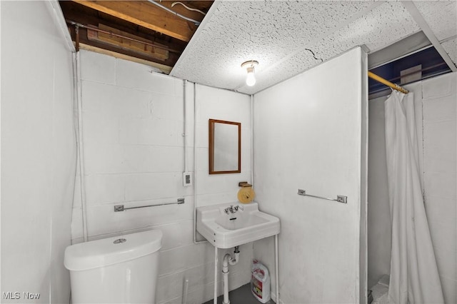 full bath featuring toilet and curtained shower