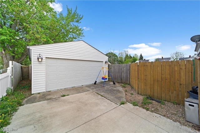 detached garage featuring fence