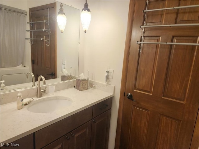 full bathroom with vanity and shower / bath combo with shower curtain