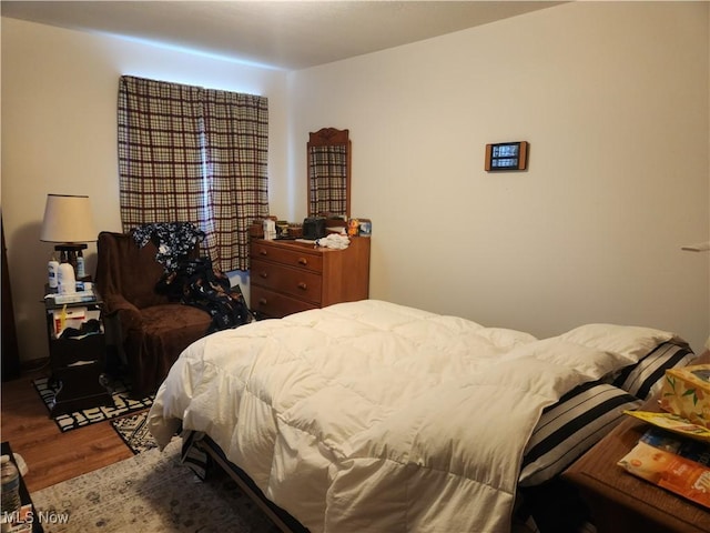bedroom with wood finished floors