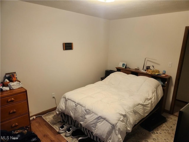 bedroom with light wood-type flooring