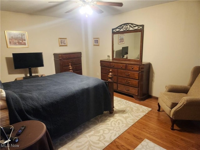 bedroom with a ceiling fan and wood finished floors