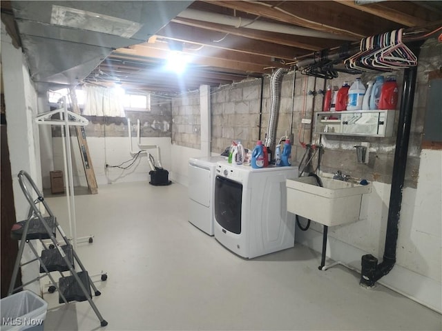 basement featuring a sink and washing machine and dryer