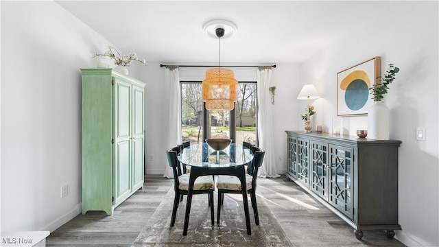 dining room with baseboards and wood finished floors