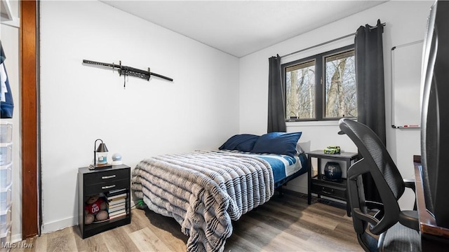 bedroom featuring baseboards and light wood-type flooring