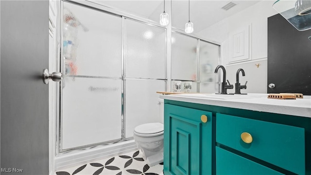 full bath with vanity, toilet, tile patterned floors, a shower stall, and visible vents