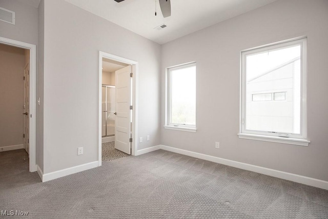 unfurnished bedroom featuring baseboards, carpet, and visible vents