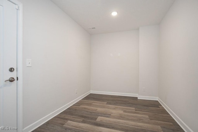 unfurnished room with dark wood-style flooring, baseboards, and recessed lighting