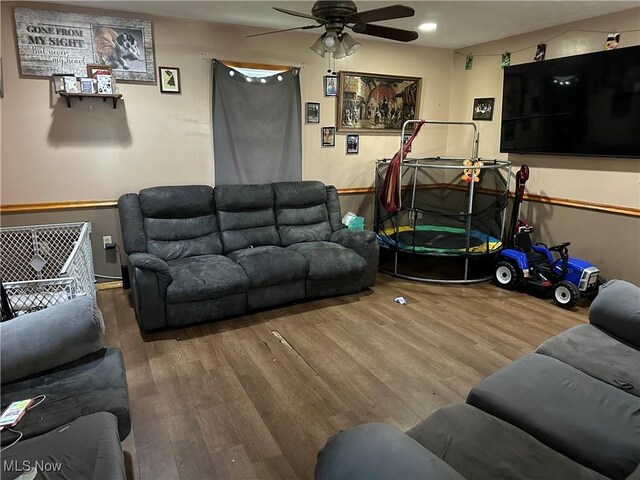 living area featuring a ceiling fan and wood finished floors