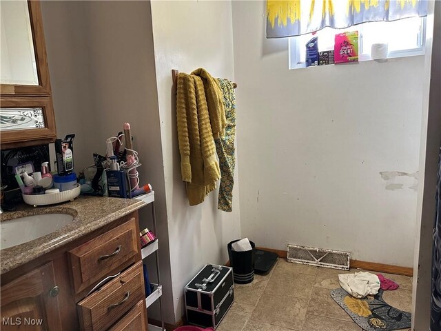 bathroom with vanity and visible vents