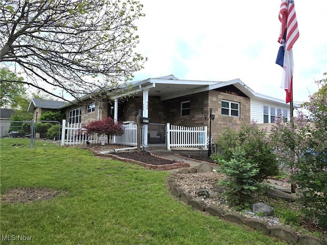rear view of property with fence and a lawn